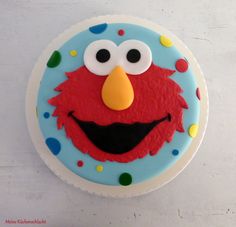 a birthday cake decorated to look like an elmo face