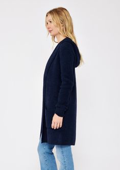 An ultra warm and cozy mid-length hooded cardigan in navy. Fuzzy texture Relaxed fit Long sleeve Mid-length Hooded Open front Patch pockets Women's fall cardigan Dry clean only Embrace all the cozy vibes in this ultra-soft long cardigan - your new Fall favorite! This versatile layering piece features an open front, a comfy hoodie, long sleeves, and convenient patch pockets. You'll find yourself reaching for this easy fit style all season long. Model is 5'7.5, wearing a size S.Style: I-51072K-SLQ Blue Hooded Winter Cardigan, Cozy Blue Sweater Coat For Winter, Cozy Navy Sweater For Winter, Cozy Blue Hooded Winter Jacket, Cozy Blue Soft Knit Outerwear, Cozy Blue Hooded Jacket For Winter, Navy Knit Winter Outerwear, Navy Knit Outerwear For Winter, Cozy Hooded Jacket For Cold Weather