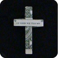 a cross with the words in god we trust written on it and money wrapped around it