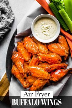 chicken wings with dipping sauce and celery on the side, ready to be eaten