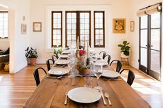 a dining room table is set with place settings