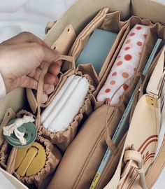 the inside of an open purse filled with personal items