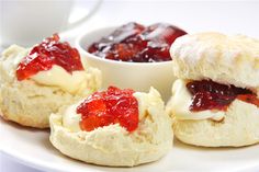 small pastries with jam on them sitting on a plate