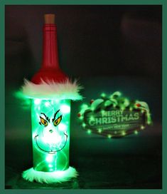 a bottle that has some lights on it and is lit up in the shape of a santa hat