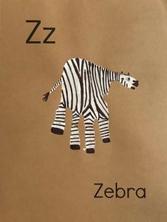 the zebra is made out of brown paper and has black letters that read zzz