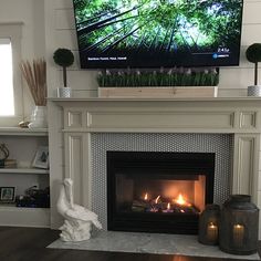 a flat screen tv mounted above a fire place