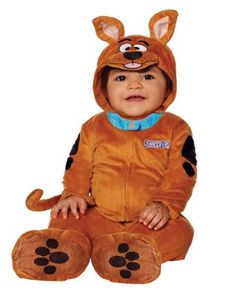 a baby in a costume sitting on the ground