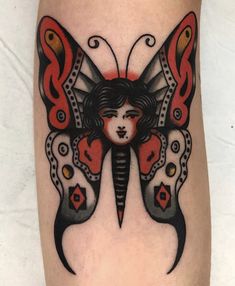 a woman's head with a butterfly tattoo on her leg and the wings are red