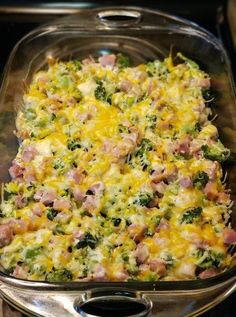 a casserole dish with ham, broccoli and cheese in it on the stove