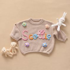 Here, we focus on creating custom and personalized baby/toddler/children's sweaters with a sense of artistic pride. Each sweater is adorned with a baby's name and hand embroidered with rough yarn on the chest. DESCRIPTION: Each sweater proves our meticulous craftsmanship, handmade and hand embroidered on high-quality, ultra soft 100% pure cotton oversized sweaters (carefully designed and crafted by us). Handembroidered baby sweaters are an excellent gift choice for baby showers, newborn/family photos, moon concept photos of babies, birthdays, baptisms, or special events. (If you want to give a personalized gift, a hand embroidered baby sweater is a perfect choice.) Each piece of work is a unique artwork, tailored specifically for you. And become more meaningful. DETAILS: ﹥Material: Cotton Personalized Pink Sweater For Winter, Customizable Cute Winter Sweater, Cute Customizable Winter Sweater, Customizable Cute Crew Neck Sweater, Cute Customizable Crew Neck Sweater, Baby Sweater With Name, Toddler Knit Sweater, Embroidered Baby Sweater, Sweater With Name