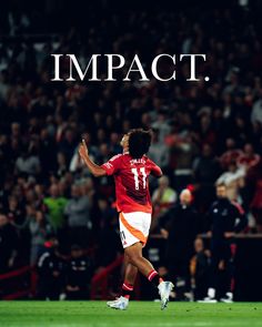 a soccer player in action with the words impact on it's back and an audience behind him