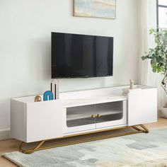 a flat screen tv sitting on top of a white entertainment center