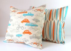 two pillows with different colored cars on them