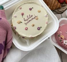 a cake with the word hello autumn written on it in front of other food items