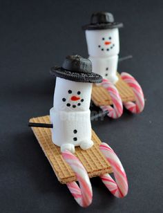 two snowmen made out of waffles and candy canes on top of each other