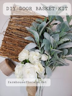 a bouquet of flowers sitting next to a basket on top of a table with the words diy door basket kit above it