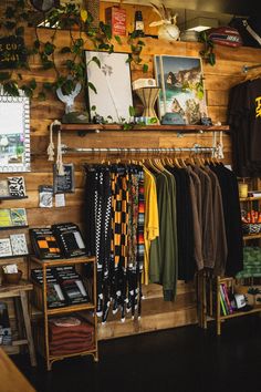 a clothing store with wooden walls and hanging items