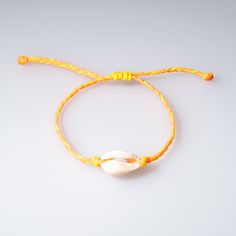 Kids Braided Cowrie Shell Bracelet - OIYA Threaded Bracelet, Cowrie Shell Bracelet, Thread Bracelets, Braids For Kids, Shell Bracelet, Cowrie Shell, Handmade With Love, Adjustable Bracelet, Yellow Orange