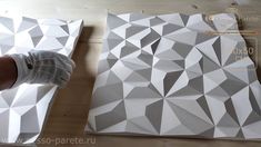 the paper is being cut out to make a geometric pattern