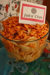 a glass bowl filled with chips on top of a table