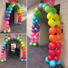 balloons are arranged in the shape of a rainbow arch at an office building entrance and hallway