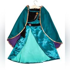 Disney Parks Frozen 2 Queen Anna Dress & Cape Youth Costume Size 11/12 New New With Tags From A Smoke Free Environment 2 Piece Set Includes: Dress And Cape Satin Dress With Velvet Overlay On Bodice Glittery Artwork Along Sleeves Decorative Velvet Belt With Badge Detail Glittery Artwork At Front And Back Slit On Skirt Reveals Contrasting Chiffon Underlay Stretchy Back For Comfortable Fit Satin Cape With Glittery Artwork And Bronze-Toned Piping Contrast Satin Lining Dress - Shell: 100% Polyester, Elsa Costume For Kids, Anna Outfit, Anna Coronation Dress, Blue Satin Skirt, Anna Coronation, Frozen Halloween, Princess Elsa Dress, Anna Costume, Coronation Dress