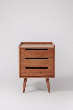 a wooden nightstand with two drawers on one side and an open drawer on the other