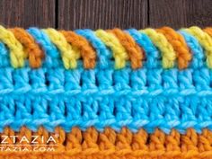 the crochet stitch is being used to make a colorful piece of fabric that looks like yarn