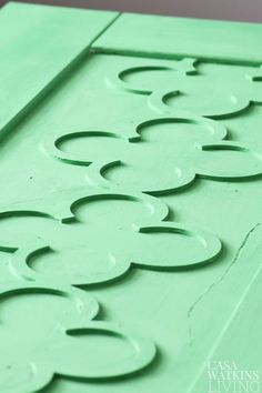 a close up of a green door with circles painted on it