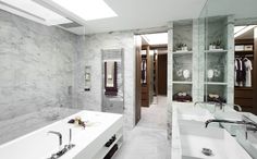 a bathroom with two sinks and a bathtub next to a walk - in shower