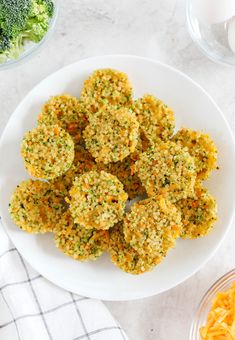 broccoli florets on a white plate next to cheese and other ingredients