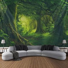 a couch sitting in front of a wall with a forest scene on it's side