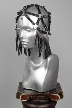 This is a one of a kind piece of wearable art made for the Five and Diamond Seventh Annual Headgear Art Show and shown on August 2, 2019. Black leather head piece made by entirely by hand. Designed by Darmara One of a kind Unisex MATERIALS USEDGenuine leather, metal rivets, stainless steel chains, black pearl rivets. WEARING INSTRUCTIONSAvoid getting piece wet.To clean, wipe down with a wet cloth then a dry cloth. Store in a dry place. All headgear sales are final. Due to the unique nature of th Head Games, Cloth Store, Unique Nature, Head Piece, Black Pearl, Art Show, Stainless Steel Chain, Rivets, Wearable Art