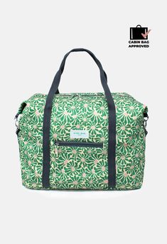 a green and white floral print duffel bag with black straps on the bottom, it has