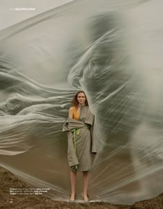 a woman standing in front of a giant sheet