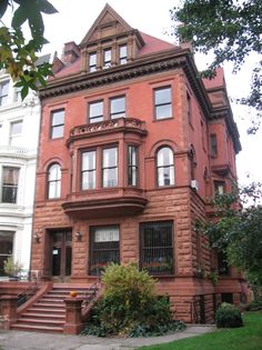 an old brick building with many windows and balconies on the second floor is shown