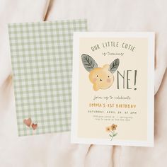 a little cute one birthday card with a bunny on it's back and a green gingham checkered background