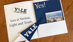 an envelope with a blue and white pennant on it, next to a note that says yle class of 2013