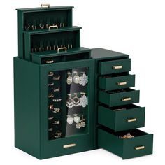 a green jewelry cabinet with several drawers and earrings on it's sides, open to reveal the contents