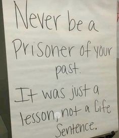 a white sign with writing on it that says never be a prisoner of your past