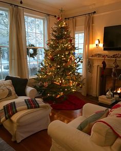 a living room with a christmas tree in the corner