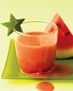 watermelon juice in a glass with a green star on the top and another piece of watermelon next to it