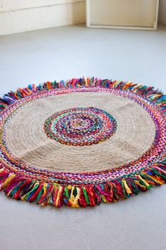 a multicolored round rug on the floor