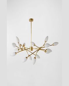 a chandelier with white and gold leaves hanging from it's center point