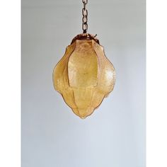 a glass light hanging from a metal chain