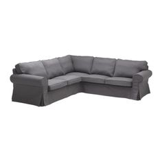 a gray sectional couch sitting on top of a white floor