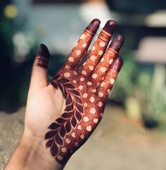 a woman's hand with henna on it and dots all over the palm