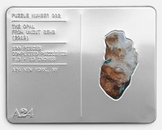 a metal plaque with a piece of rock on it's side and information about the mineral