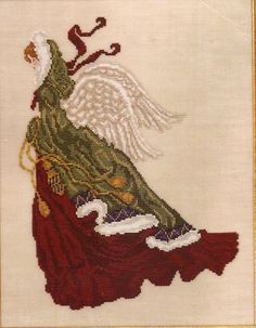 a cross stitched picture of a woman with long hair and an angel on her back