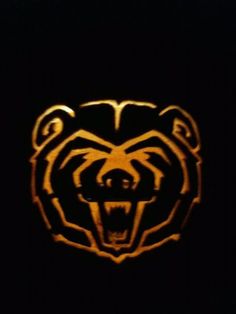 a bear head carved into the side of a black wall with orange highlights on it